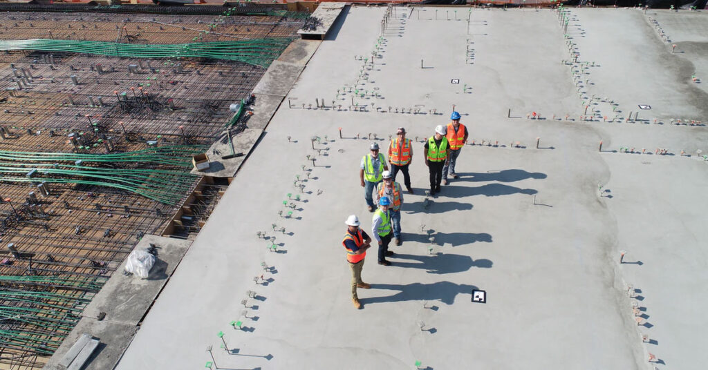 Construction workers on concrete slab