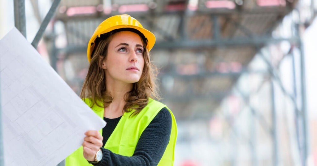 Female construction worker holding a blueprint